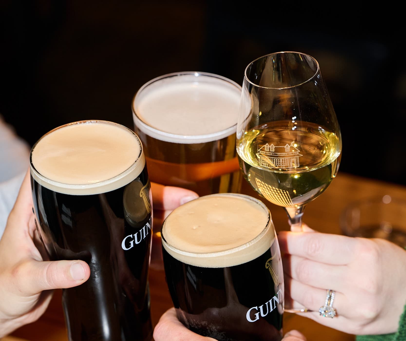 Two pints of Guinness, a lager and a glass of white clinking at MacTaverne in Val-David.
